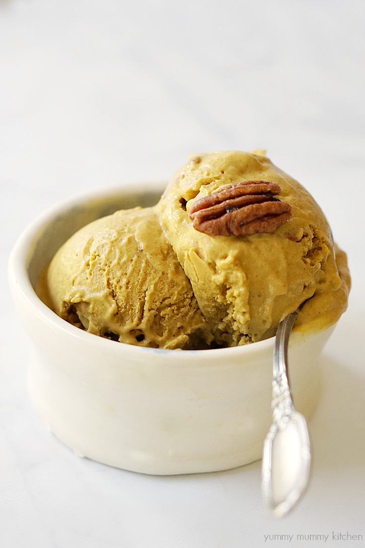 Vegan pumpkin ice cream in a bowl A bowl of coconut milk based pumpkin pie ice cream topped with pecans.