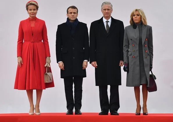 Queen Mathilde wearing a Christian Dior couture coat dress. Brigitte Macron wore Ralph Louren coat, dress and pumps