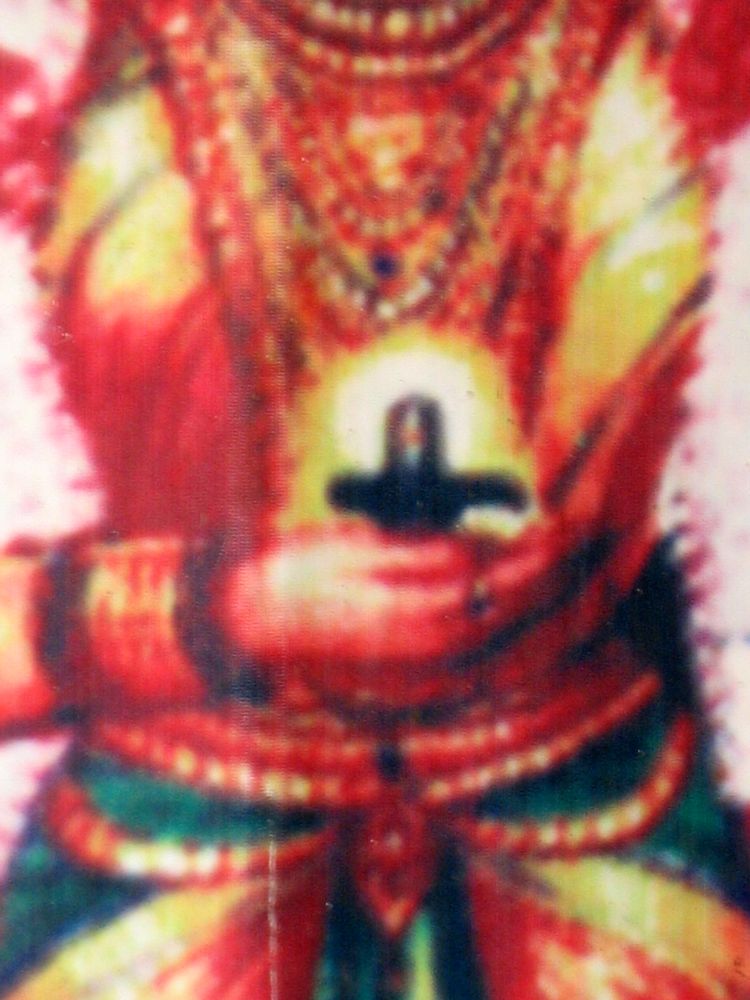 Goddess Durga at the Kamakshi Temple holding a Shiva Lingam in her hand which is pressed against her heart
