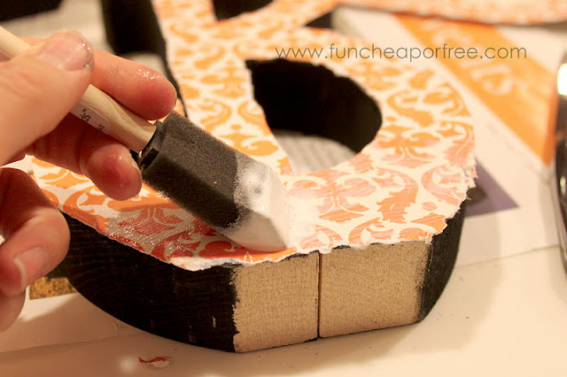 Putting Mod Podge on top of paper, from Fun Cheap or Free