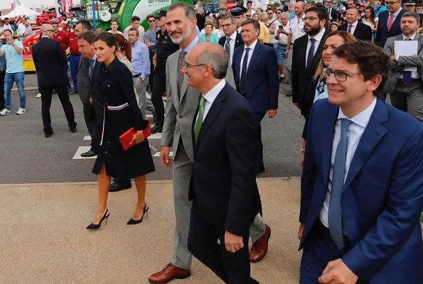 Queen Letizia wore HUGO BOSS Caddli Stretch Denim Dress, Carolina Herrera pumps, Angel Schlesser Clutch Bag