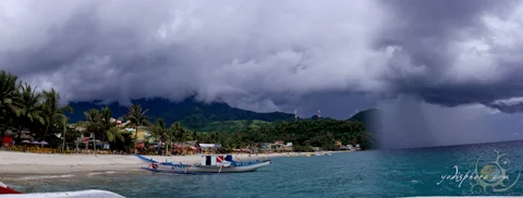 Rain approaching the coastline in White Beach Puerto Galera. 