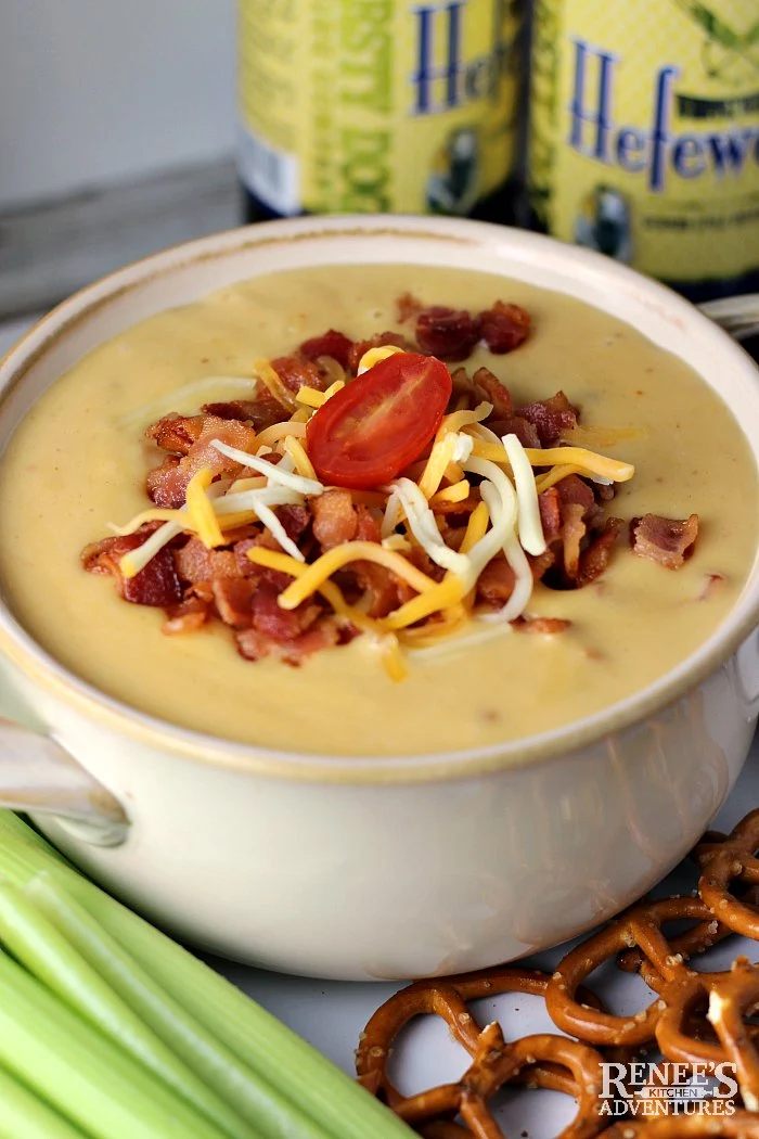 Beer Cheese Dip with Bacon in bowl with tomato garnish