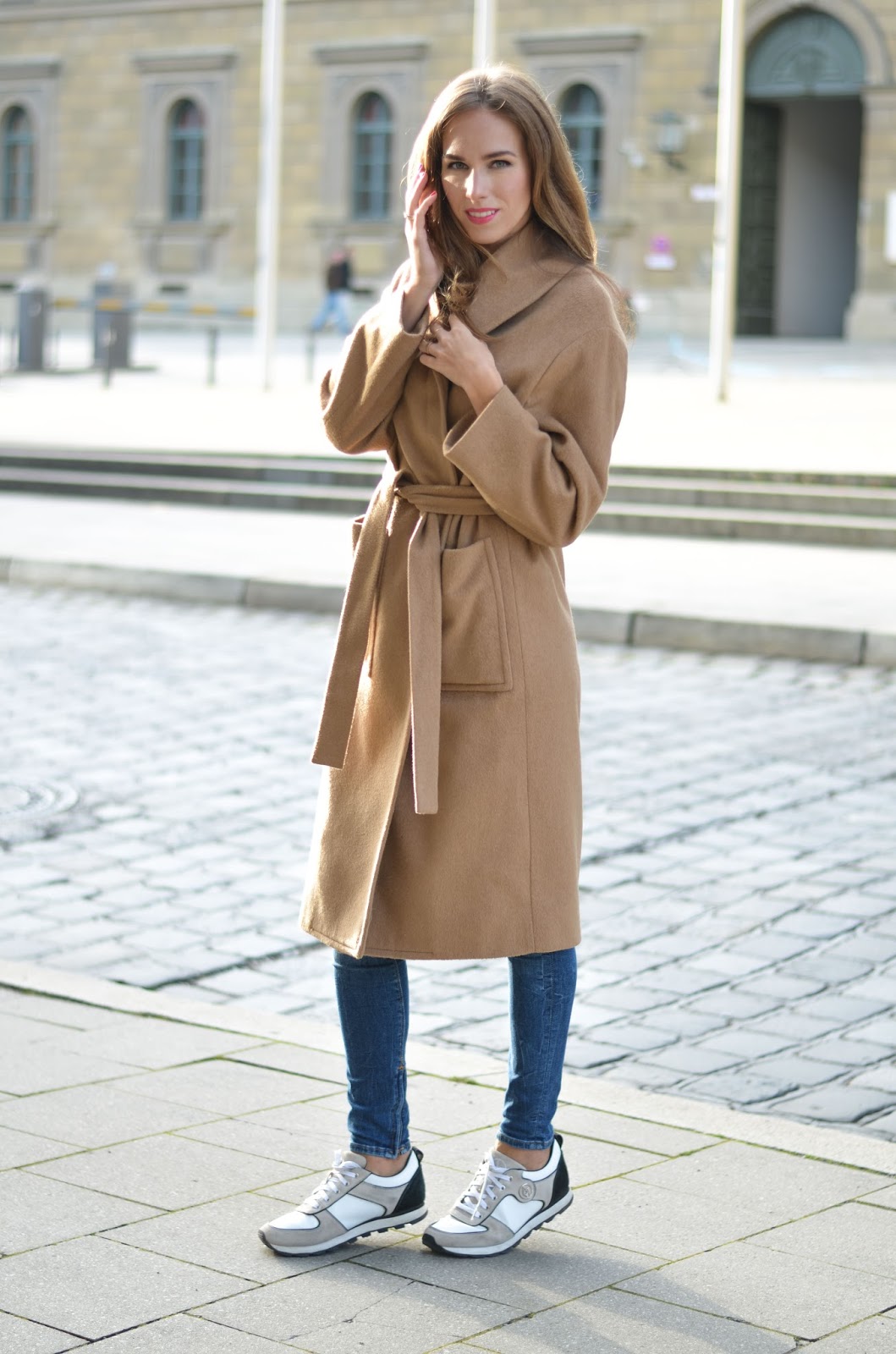 kristjaana mere camel coat fall outfit with skinny jeans white sneakers