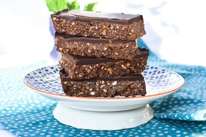 Stack of No Bake Peanut Butter & Cornflake Chocolate Tiffin on blue and white patterned plate