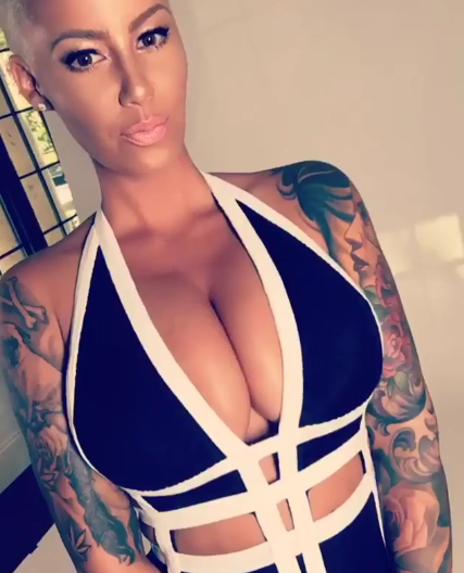 Amber Rose puts her massive boobs on display in new photos.