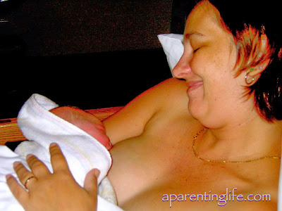 Mother with newborn babe at her breast