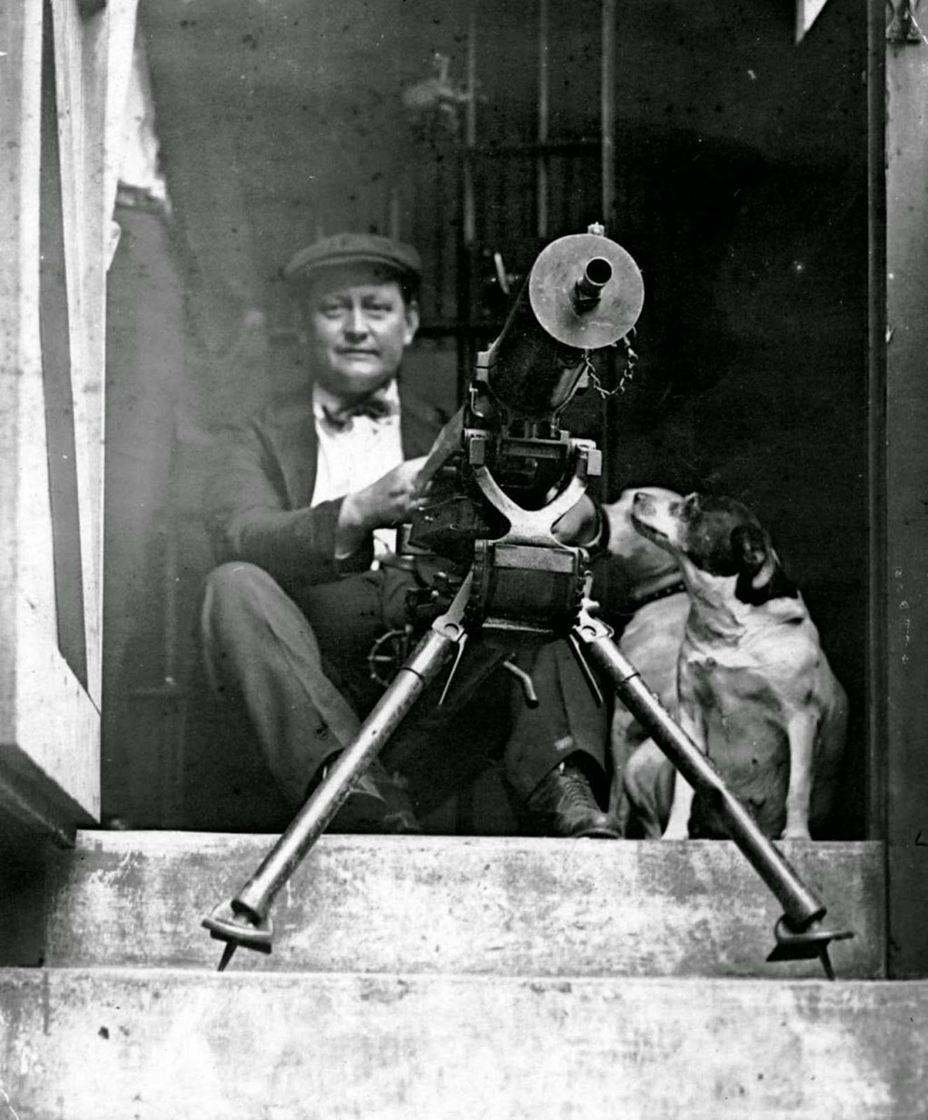 A man armed with a machine gun sits at the Cook County Jail during the 1919 Chicago race riots.