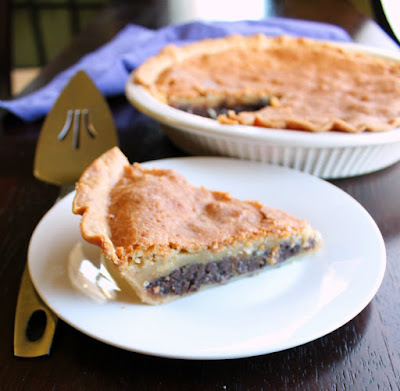 If you like soft and gooey chocolate chip cookies, toll house pie is for you. This recipe has more filling than most for extra goodness in every bite! showing layers of slice of pie