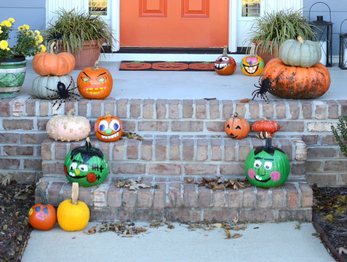 Monster painted pumpkins, a diy monster door make this front stoop Halloween ready. 