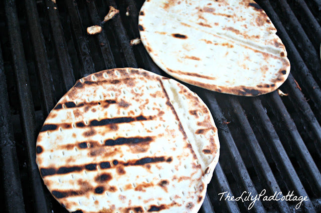 A close up of a slice of pita on a grill