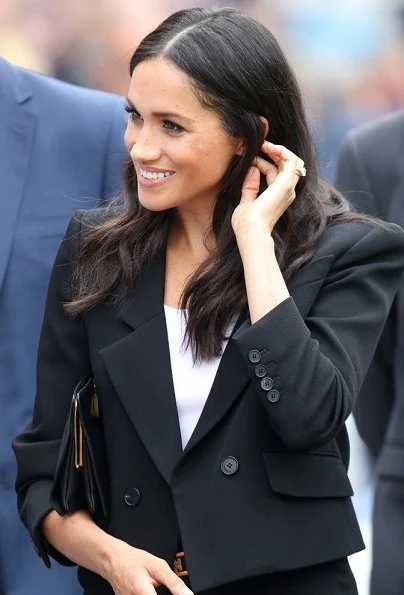 Meghan Markle wore Givenchy black cropped double-breasted blazer and trousers, Sarah Flint Pumps, she carried Givenchy GV3 frame clutch bag