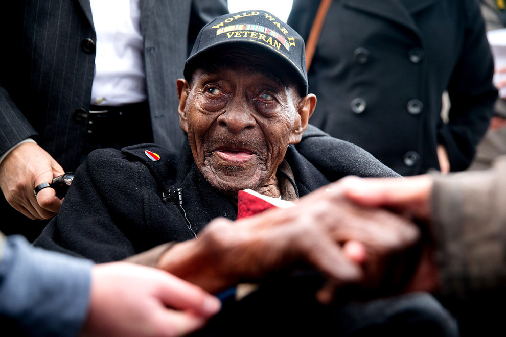 70 Of The Most Touching Photos Taken In 2015 - Frank Levingston Jr., who at 110 is America’s oldest military veteran, is greeted by visitors at a ceremony to mark the anniversary of Pearl Harbor.