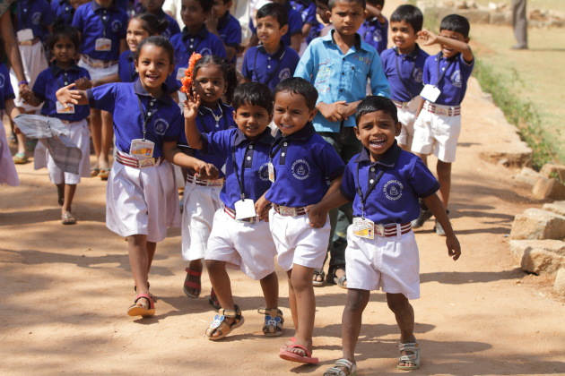 Smiling school kids on a picnic to the heritage site of Hampi, Karnataka, India