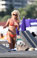 Victoria Silvstedt shows off her body in an orange bikini