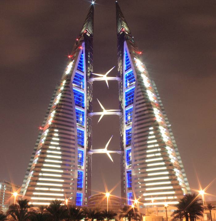 The Bahrain World Trade Center is a 240 m (787 ft) high twin tower complex located in Manama, Bahrain. The towers were built in 2008 by the multi-national architectural firm Atkins. It is the first skyscraper in the world to integrate wind turbines into its design. The wind turbines were developed, built and installed by Danish company Norwin A/S. This 50-floor structure is constructed in close proximity to the King Faisal Highway, near popular landmarks such as the towers of BFH, NBB and Abraj Al Lulu.