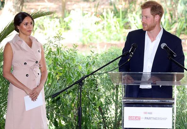 Meghan Markle wore a double breasted trench dress by Banana Republic and suede pumps by Stuart Weitzman