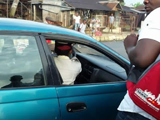 Photos: Female FRSC official in Akwa Ibom pictured dragging steering wheel with a driver in moving vehicle