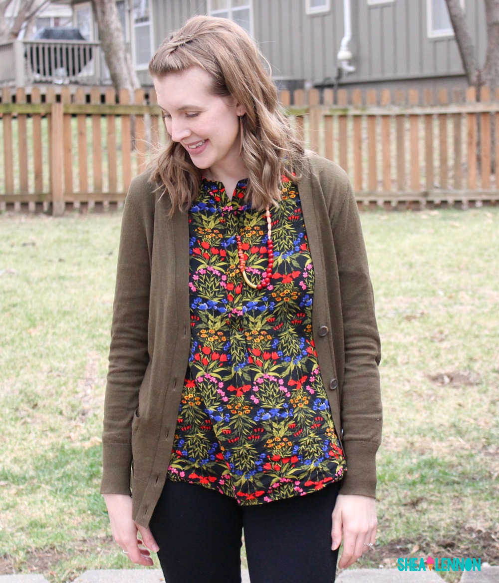 Winter outfit idea featuring a floral top, olive cardigan, ponte pants, and over the knee boots. 