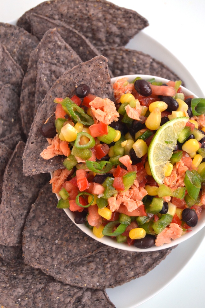 Salmon Texas Caviar is a delicious black bean, tomato, corn and bell pepper salad with salmon and a tangy lime vinaigrette. Serve as a salad or as an appetizer with tortilla chips! www.nutritionistreviews.com