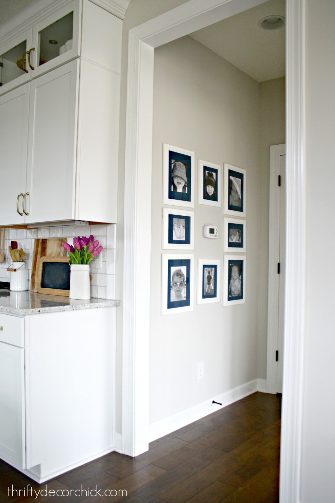 Art wall around the thermostat (and a hanging art hack) from Thrifty