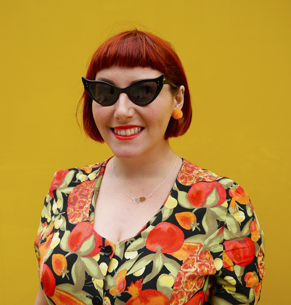 Pom Poms and Playsuits - Summer Style on Wardrobe Conversations Wardrobe Conversations, Scottish blogger, Scot Street style, Edinburgh Blogger, Edinburgh street style, vintage street style, summer outfit, summer street style, playsuit, fruit pattern playsuit, vintage playsuit, umbrella, watermelon umbrella, colourful blogger style, bright colours, Nicely Eclectic vintage, Paperchae umbrella, Vintage sunglasses, cat eye sunglasses, summer style, summer tan, fake tan, natural fake tan, easy fake tan, tanning tips, Bellamianta fake tan, tanning mousse, pom pom earrings, DIY jewellery
