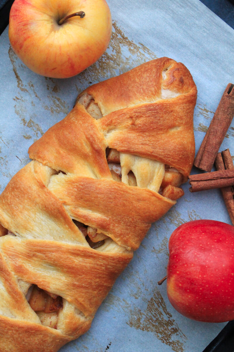 Golden crescent rolls are braided around a sweetened cream cheese and cinnamon apple filling in this pretty Cinnamon Apple Crescent Braid that can be served as breakfast or a dessert!