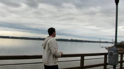 Man looking out onto the Paraná River in Posadas, Argentina