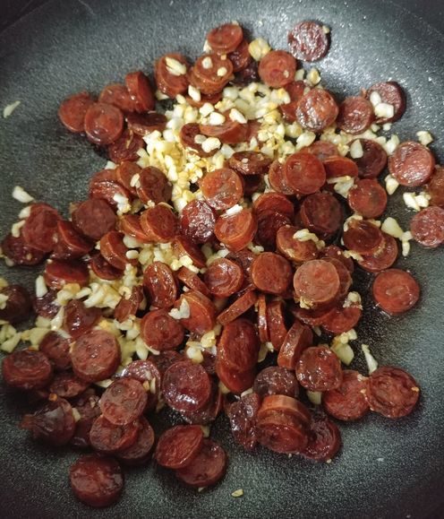 Frying the chorizo and garlic for the pasta recipe
