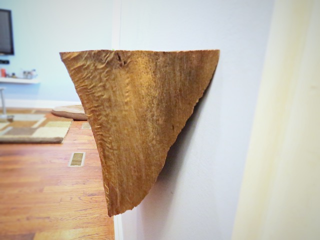side view of wood wedge on wall