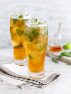 Honey Badger Cocktail in a pint glass with lots of ice and mint