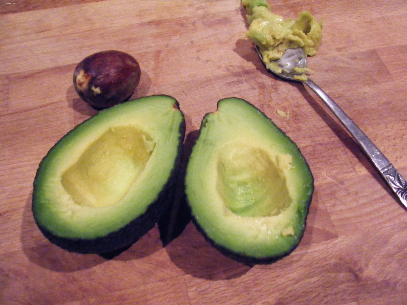 avocado flesh sliced on chopping board