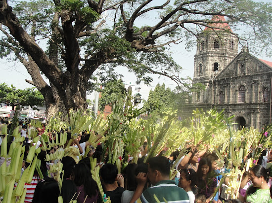 Filipinos celebrating Linggo ng Palaspas or Palm Sunday.