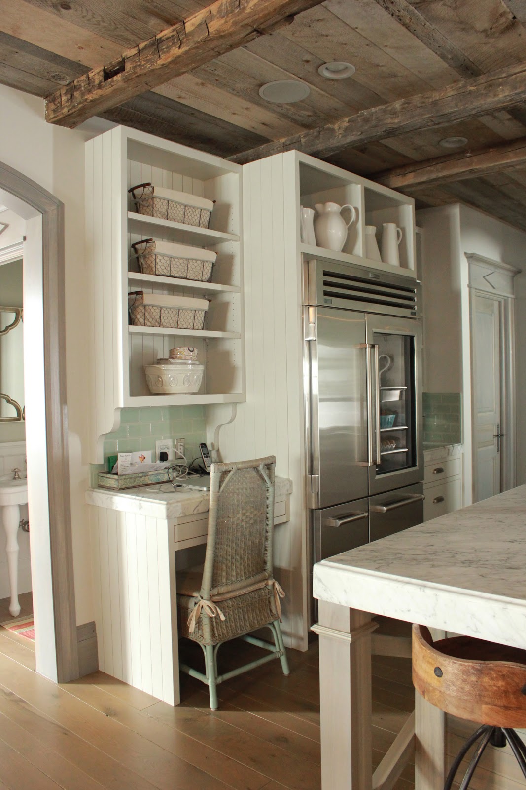 Magnificent Gustavian French kitchen in stone cottage with rustic interiors, reclaimed wood ceilings, blue-grey, green, and collected European antiques. Designed by Desiree Ashworth. Find ideas for grey, blue, and green paint colors.