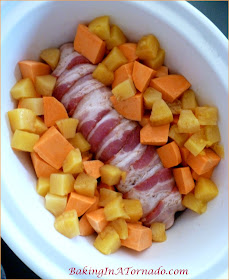 Maple Pineapple Pork Tenderloin, pork tenderloin wrapped in bacon with sweet potatoes and pineapple slow cooked in an easy sauce. | Recipe developed by www.BakingInATornado.com | #recipe #CrockPot #dinner