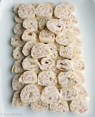 Zesty beef roll-ups are the perfect two bite appetizers. They are creamy, cheesy, zesty, salty and oh so snackable! platter filled with bite sized pinwheels