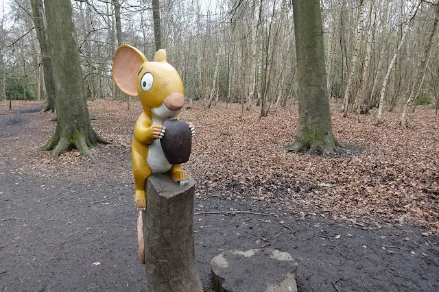 A wooden carved large mouse from The Gruffalo holding a large nut