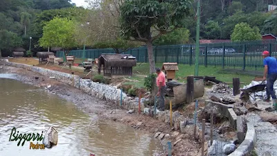 Construção do muro de pedra em volta do lago, com pedra rachão, para evitar o desmoronamento do barranco em volta do lago. Muro de pedra em Cotia-SP.