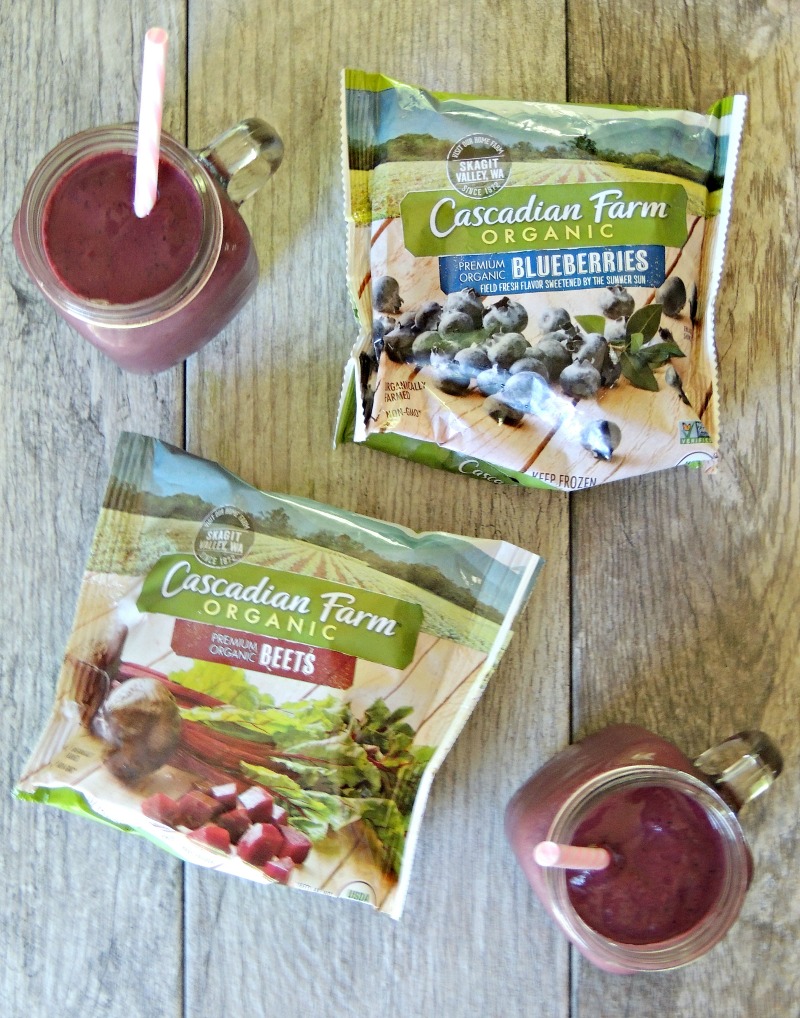 2 Blueberry and Beet Smoothie on a tile background with 2 bags of Cascadian Farm Organic frozen blueberries and beets