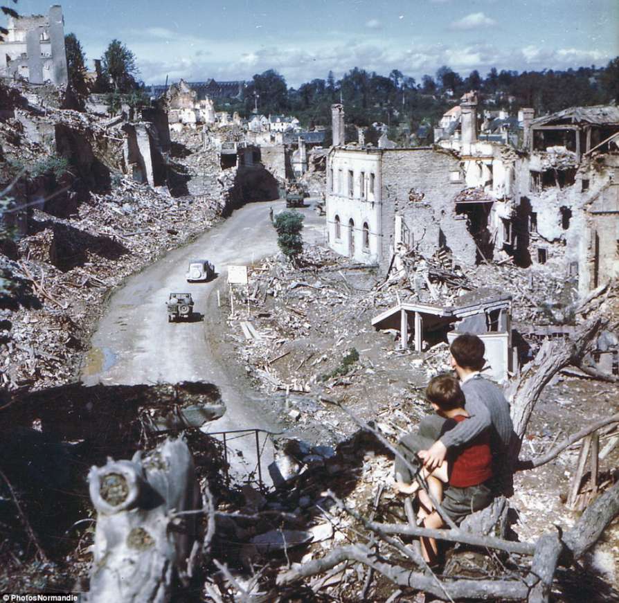 1+In+the+aftermath+of+the+D-Day+invasion,+two+boys+watch+from+a+hilltop+as+American+soldiers+drive+through+the+town+of+St.+Lo.+France,+1944-894.jpg