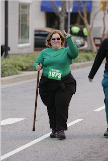 Me with my renaissance walking stick, wearing a green shirt, black pants, race number 1673. I'm giving the photographer a piece sign with my fingers