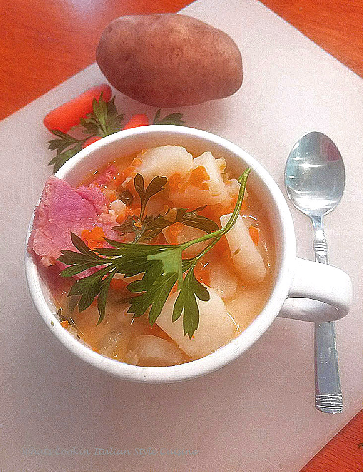 This is the easiest way to make potato soup. This soup is a potato soup with ham, it's a no fuss soup with vegetables ham and very low in calories. This potato soup has carrots, celery, ham all in a rich creamy broth made all in one pan. This is in a soup cup with vegetable design on it.