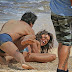 Irina Shayk rolls around topless in the sand with male model as she shoots for Sports Illustrated in Hawaii 