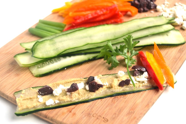 Cucumber Hummus Roll Ups are an easy and healthy appetizer that take 10 minutes to make and are perfect for entertaining! Made with hummus, feta and fresh vegetables. www.nutritionistreviews.com