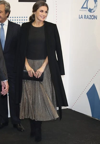 Queen Letizia wore pleated sequin midi skirt, carried Nina Ricci arch clutch bag and Carolina Herrera wool coat