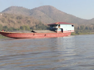 Large cargo barges on the Mekong river in Luang Prabang.