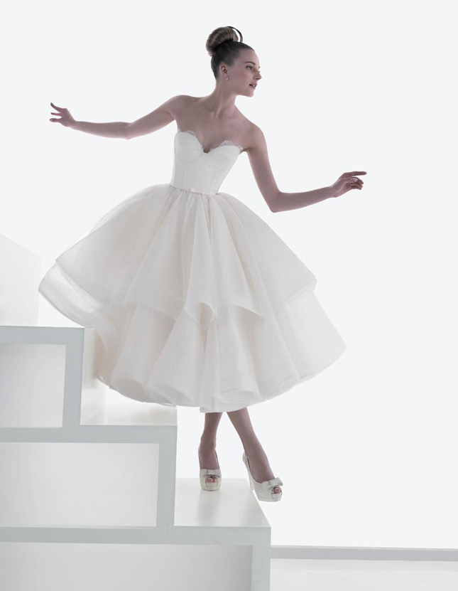 A model on her wedding day in a tea-length wedding dress