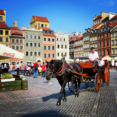 Horse and carriage passing through the Market Square in Old Town Warsaw