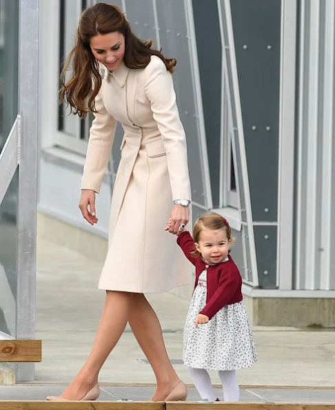 Kate Middleton wore wore a cream coat by Catherine Walker. L.K. Bennett Floret shoes. Cartier Ballon Bleu watch. Annoushka pearls with Kiki McDonough hoops earrings