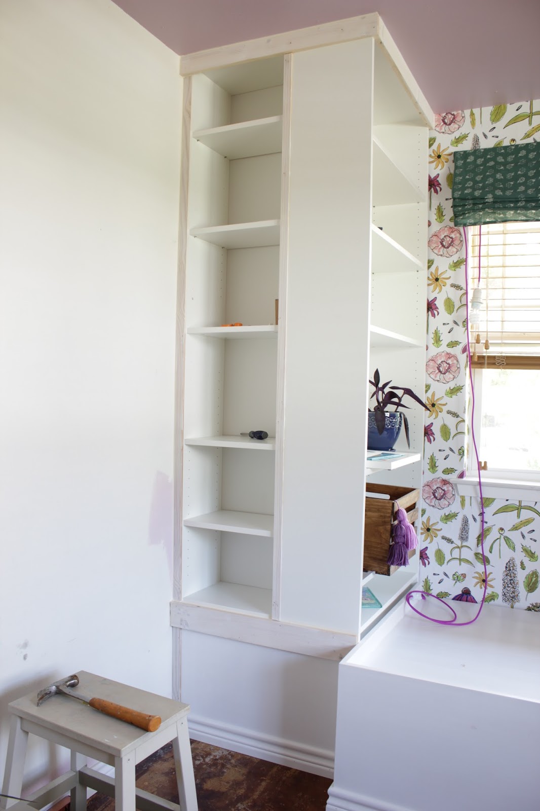 We transformed this space with built ins using Ikea bookshelves. This daybed space is so versitile and provides so much storage. 